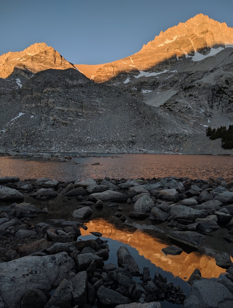 The first rays of the morning sun are painting cliffs glowing gold. Photo credit: Andrew Kiselev.